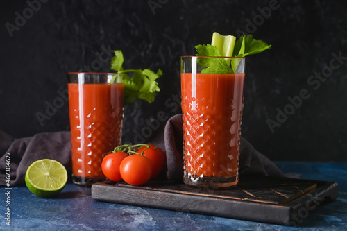 Glasses of bloody mary with celery and tomatoes on table © Pixel-Shot