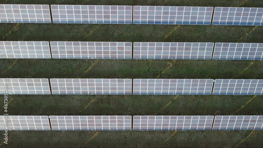 Aerial top view of a solar panels power plant. Photovoltaic solar panels at sunrise and sunset in countryside from above. Modern technology, climate care, earth saving, renewable energy concept. Aerial top view of a solar panels power plant. Photovoltaic solar panels at sunrise and sunset in countryside from above. Modern technology, climate care, earth saving, renewable energy concept.