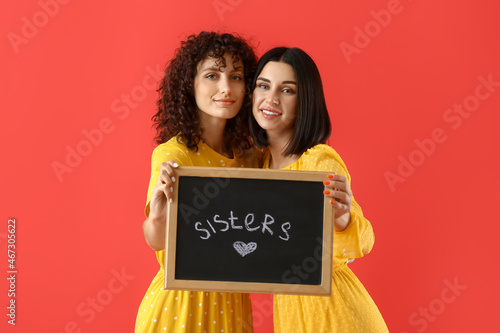 Young women holding board w...
