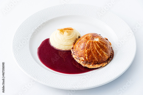 ..Tenderloin with pork, mushrooms and sirloin puff pastry on a white background. Homemade meal for wellington. photo