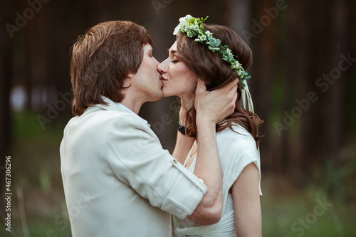 couple in love walks through the forest in wedding dresses