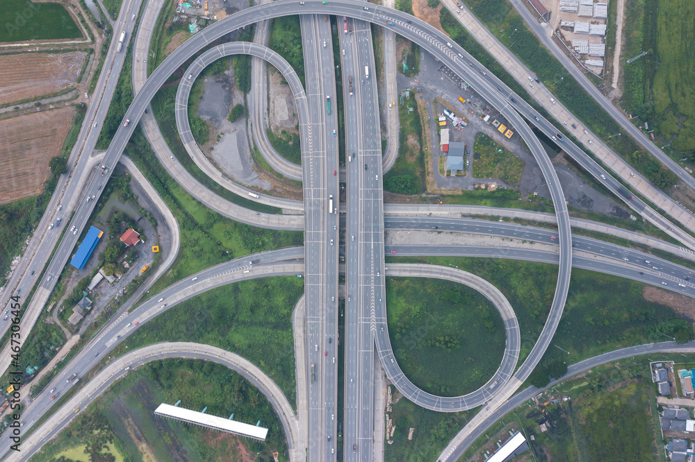 Aerial view of highway junctions with roundabout. Bridge roads shape circle in structure of architecture and transportation concept. Top view. Urban city, Bangkok at sunset, Thailand Aerial view of highway junctions with roundabout. Bridge roads shape circle in structure of architecture and transportation concept. Top view. Urban city, Bangkok at sunset, Thailand