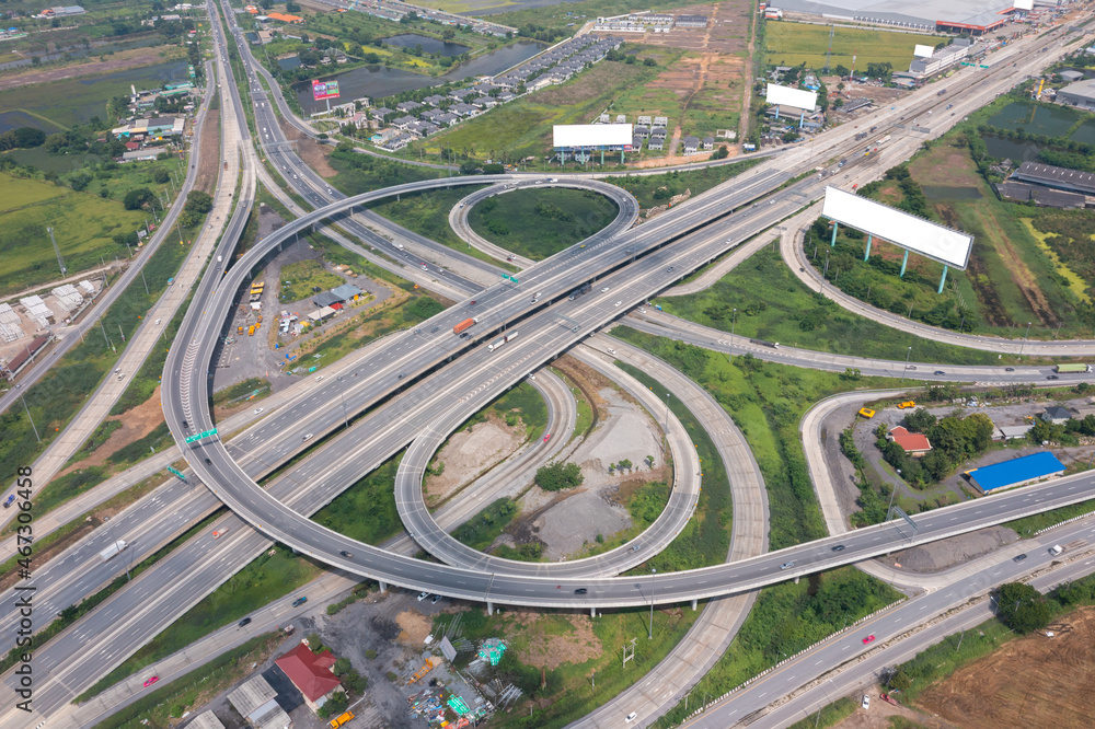 Aerial view of highway junctions with roundabout. Bridge roads shape circle in structure of architecture and transportation concept. Top view. Urban city, Bangkok at sunset, Thailand Aerial view of highway junctions with roundabout. Bridge roads shape circle in structure of architecture and transportation concept. Top view. Urban city, Bangkok at sunset, Thailand