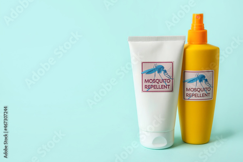 Mosquito repellent cream and spray on blue background photo