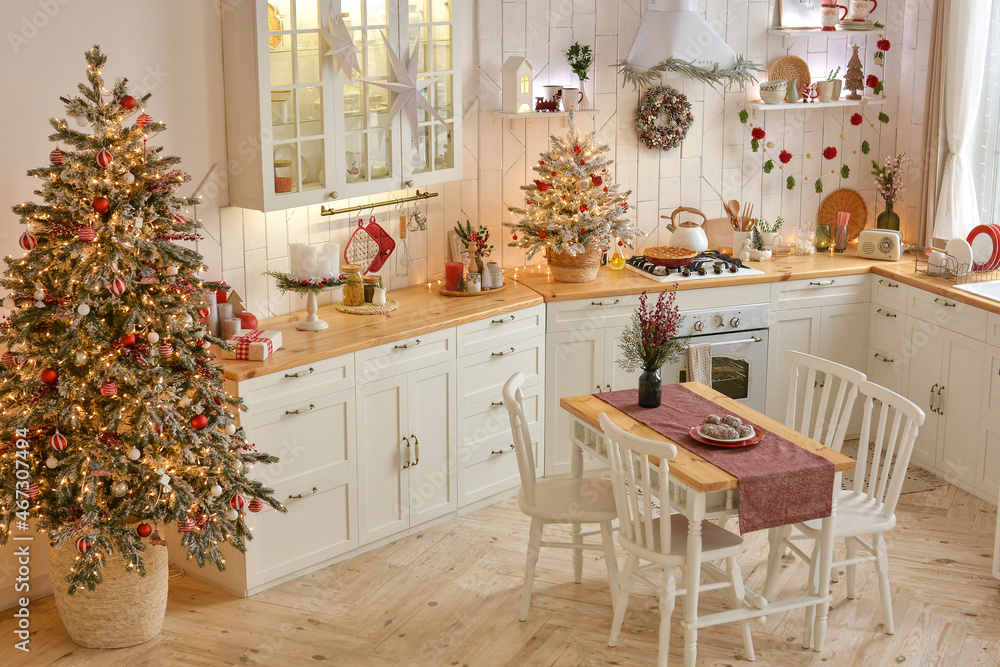 Interior of a light white сhristmas kitchen with red decor elements in the Scandinavian style. Christmas decorations. Breakfast
