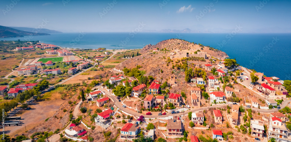 Сharm of the ancient cities of Europe. Bright view from flying drone of Astros port. Sunny summer seascape of Myrtoan Sea. Colorful scene of Arcadia region, Greece. Traveling concept background.