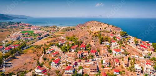 Fototapeta Naklejka Na Ścianę i Meble -  Сharm of the ancient cities of Europe. Bright view from flying drone of Astros port. Sunny summer seascape of Myrtoan Sea. Colorful scene of Arcadia region, Greece. Traveling concept background.