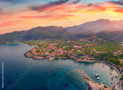 View from flying drone of Kardamyli port. Calm morning seascape of Mediterranean sea. Colorful sunrise on Peloponnese peninsula, Greece. Traveling concept background.