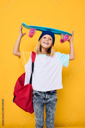 teenager with a skateboard on his head yellow background