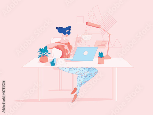 Digital freelancer graphic designer woman works in a nicely decorated modern agency office on a laptop