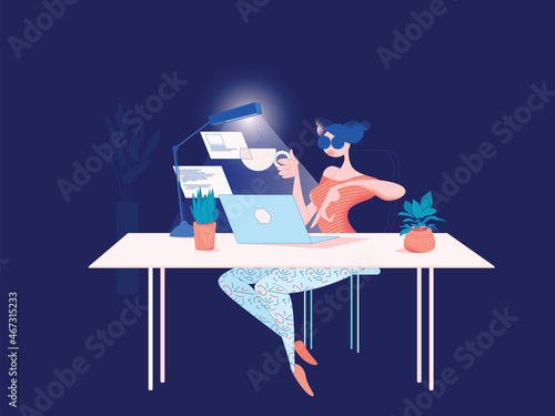 Digital freelancer woman works in a nicely decorated modern office late night on a laptop