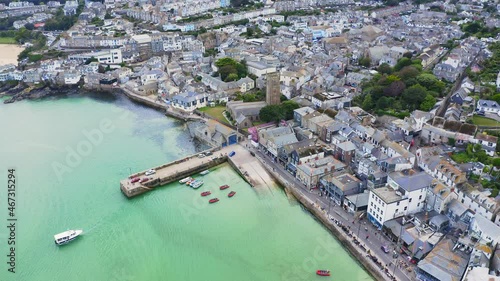 Structured St Ives harbour tourist ship departing port aerial photo