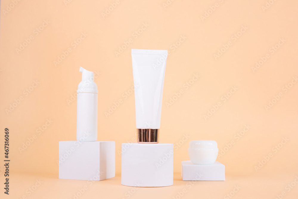 Set of White Creams tube mockup on white podium on beige background. Set of White Creams tube mockup on white podium on beige background.