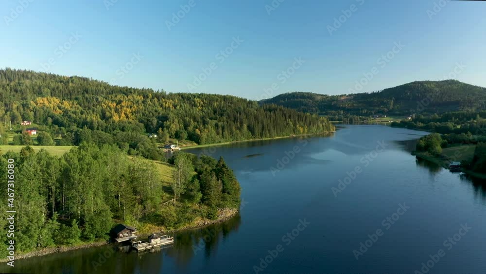 Aerial drone footage from the archipelago at the High Coast in northern Sweden. Fjord landscape with mountains and ocean bay.