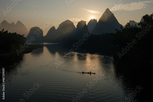 Li river on sunrise, man silhouette photo