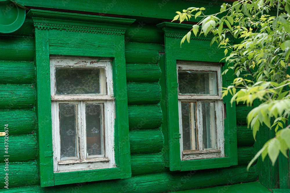The beautiful old windows with beautifully designed platbands window on an old wooden house in the city of Tula The beautiful old windows with beautifully designed platbands window on an old wooden house in the city of Tula