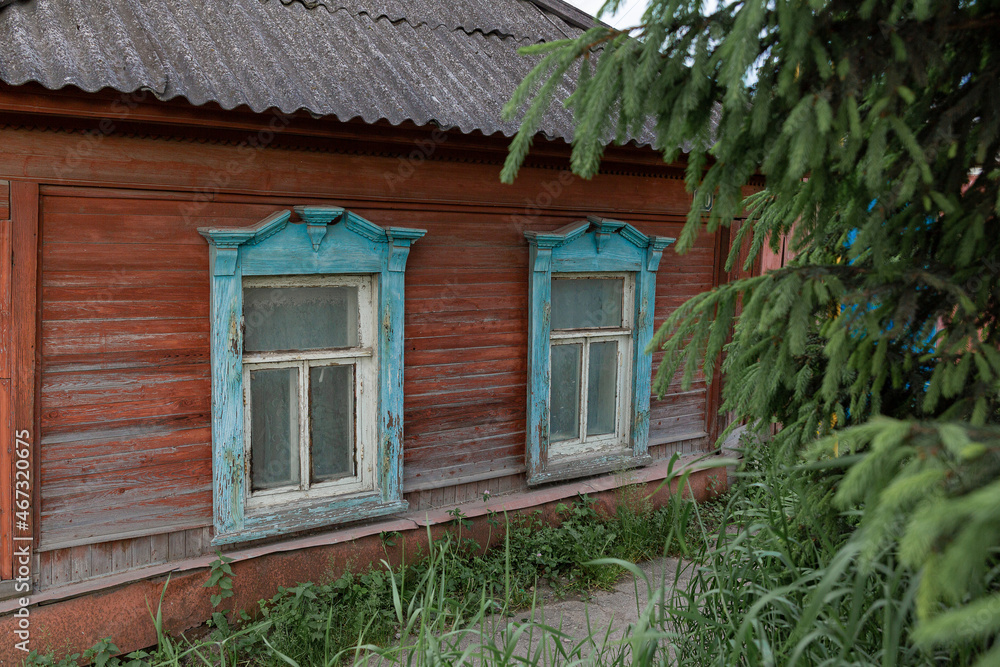 The beautiful old windows with beautifully designed platbands window on an old wooden house in the city of Tula The beautiful old windows with beautifully designed platbands window on an old wooden house in the city of Tula