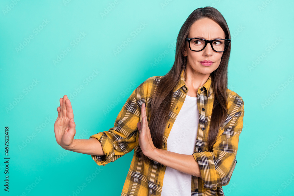 Photo of sad mature lady decline empty space wear spectacles yellow shirt isolated on turquoise color background Photo of sad mature lady decline empty space wear spectacles yellow shirt isolated on turquoise color background