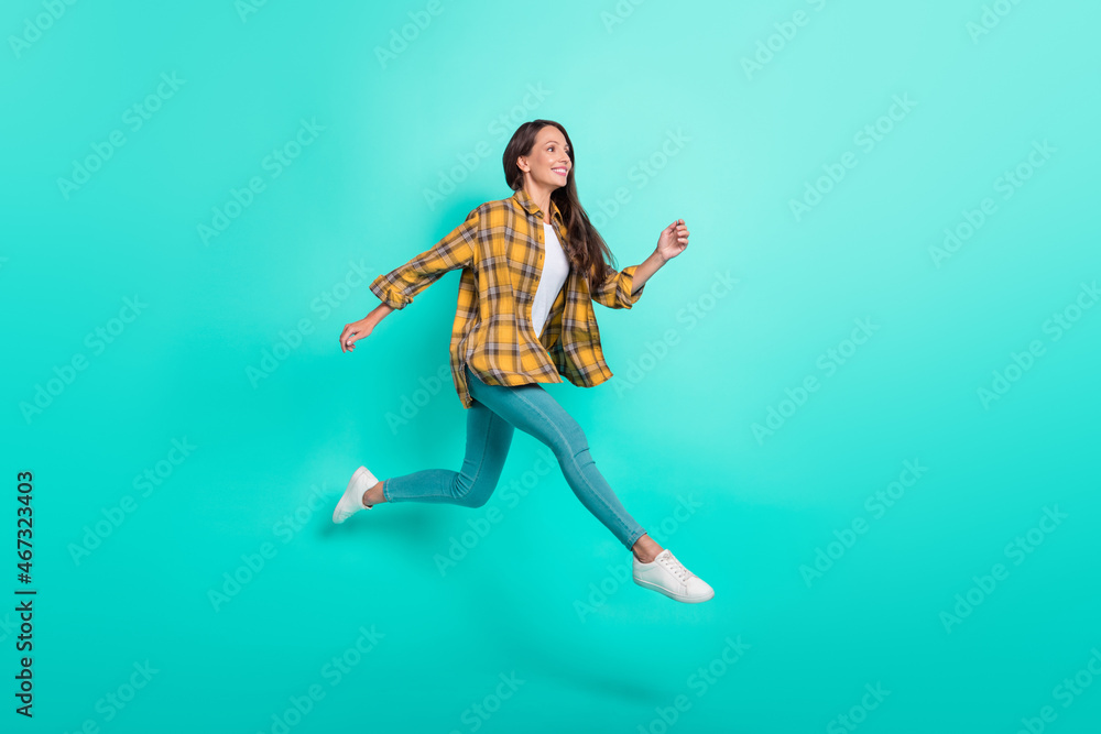Full body profile photo of young active brunette lady run wear shirt jeans sneakers isolated on turquoise background Full body profile photo of young active brunette lady run wear shirt jeans sneakers isolated on turquoise background