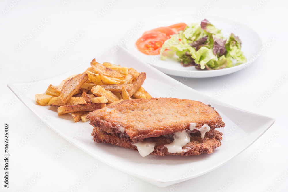 steak filled cheese and ham (san jacobo, librito) with salad and potatoes chips