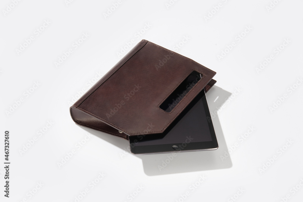 Handmade genuine leather case for a tablet or laptop on a white isolated background. Handmade genuine leather case for a tablet or laptop on a white isolated background.