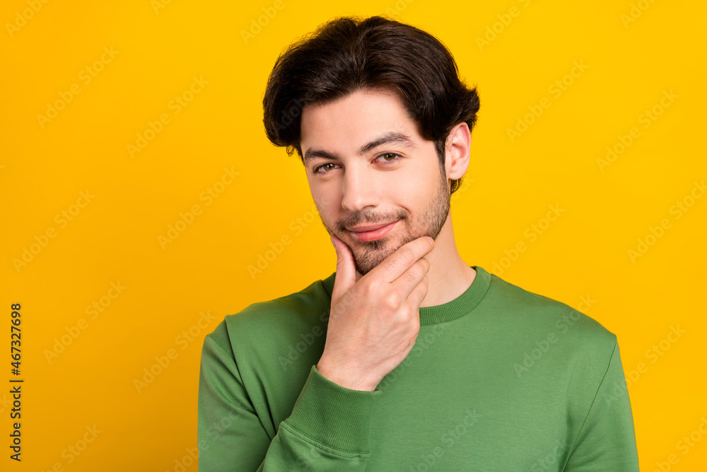 Photo of clever intelligent cunning guy think finger chin wear green pullover isolated yellow color background Photo of clever intelligent cunning guy think finger chin wear green pullover isolated yellow color background