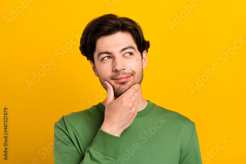 Photo of young happy minded thoughtful man look empty space idea plan smart isolated on yellow color background