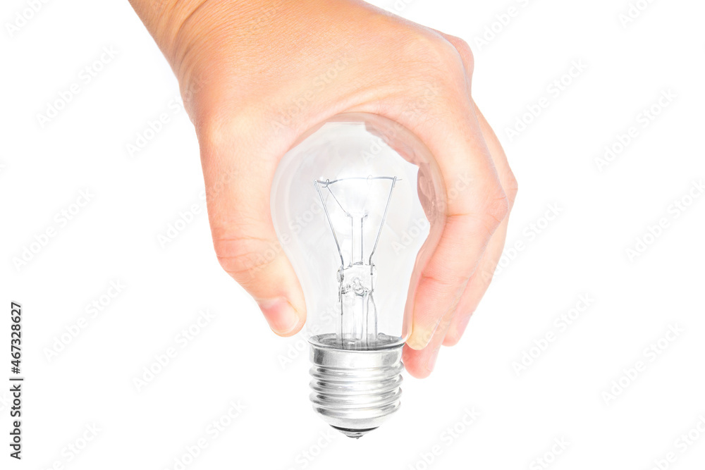 Incandescent lightbulb in hand isolated on white Incandescent lightbulb in hand isolated on white