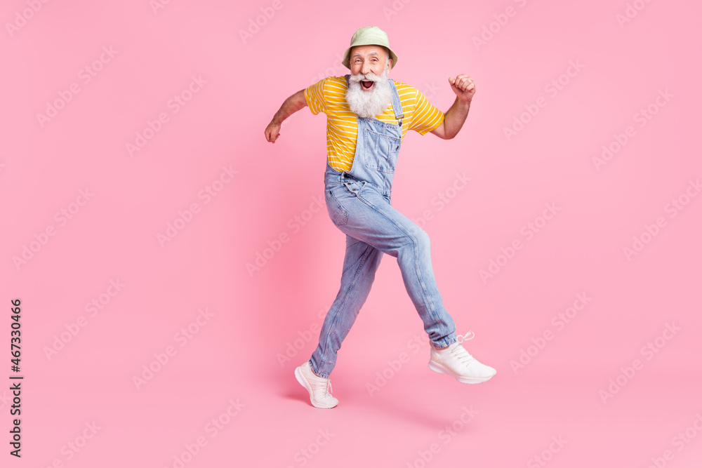 Full length body size view of attractive cheerful lucky man running fooling isolated over pink pastel color background Full length body size view of attractive cheerful lucky man running fooling isolated over pink pastel color background