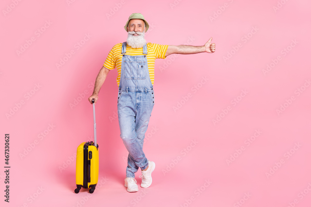 Full length body size view of attractive retired cheerful man traveling abroad isolated over pink pastel color background Full length body size view of attractive retired cheerful man traveling abroad isolated over pink pastel color background