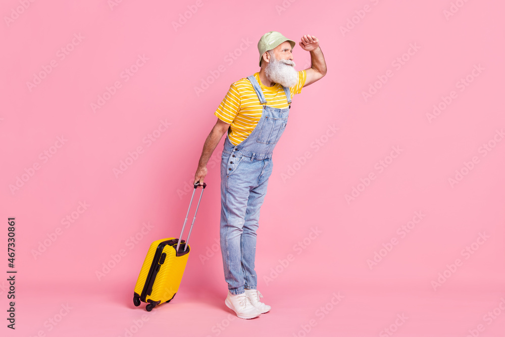 Full length body size view of attractive focused man carrying bag