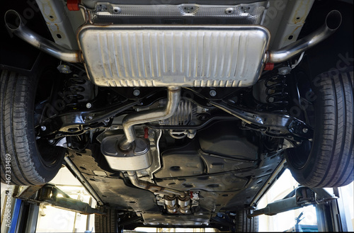 Modern powerful car on a lift in a car service.