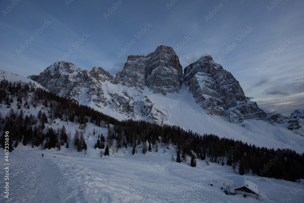 Illustration with oil painting technique of dolomite hut at the foots of the majestic north face of Mount Pelmo in winter. Selva di Cadore, Dolomites, Italy