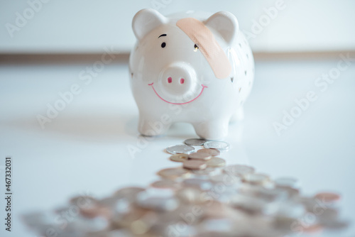 The piggy bank with a patch with plenty of coins. Banking financial liquidity.