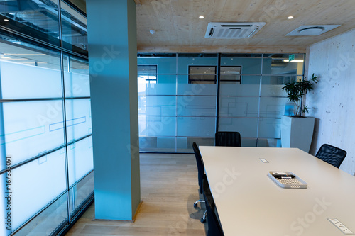 Empty modern board room with conference table and glass walls in office