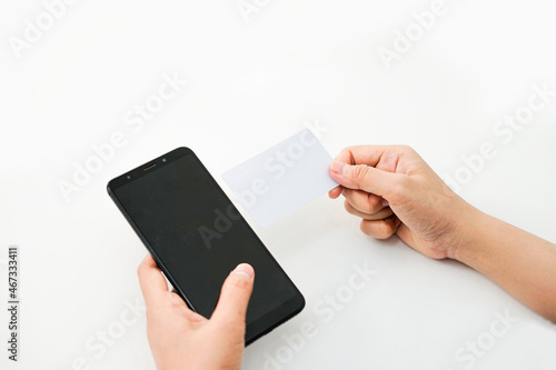 hands are holding a phone in the left and an empty card in the right. a graphic resource for mockup.