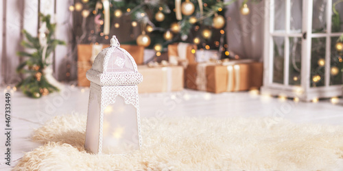 Vintage Christmas background. Christmas lantern with christmas decoration against fir tree blur lights. Festive moon, magic light. Panorama format for site banner, copy space, selected focus