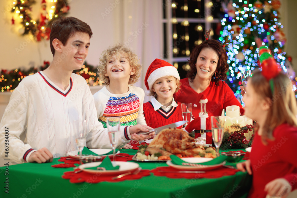 Christmas dinner. Family with kids at Xmas tree. Christmas dinner. Family with kids at Xmas tree.
