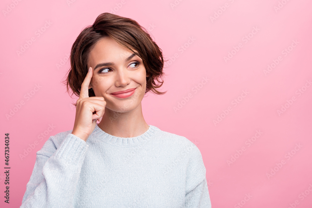 Photo of dreamy happy positive minded young woman look empty space finger temple isolated on pink color background Photo of dreamy happy positive minded young woman look empty space finger temple isolated on pink color background