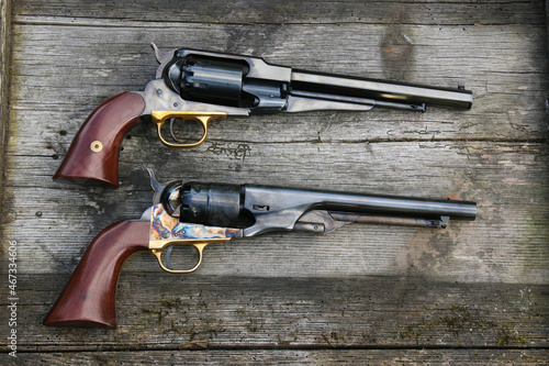 Fotografie Black powder revolvers on an old board.