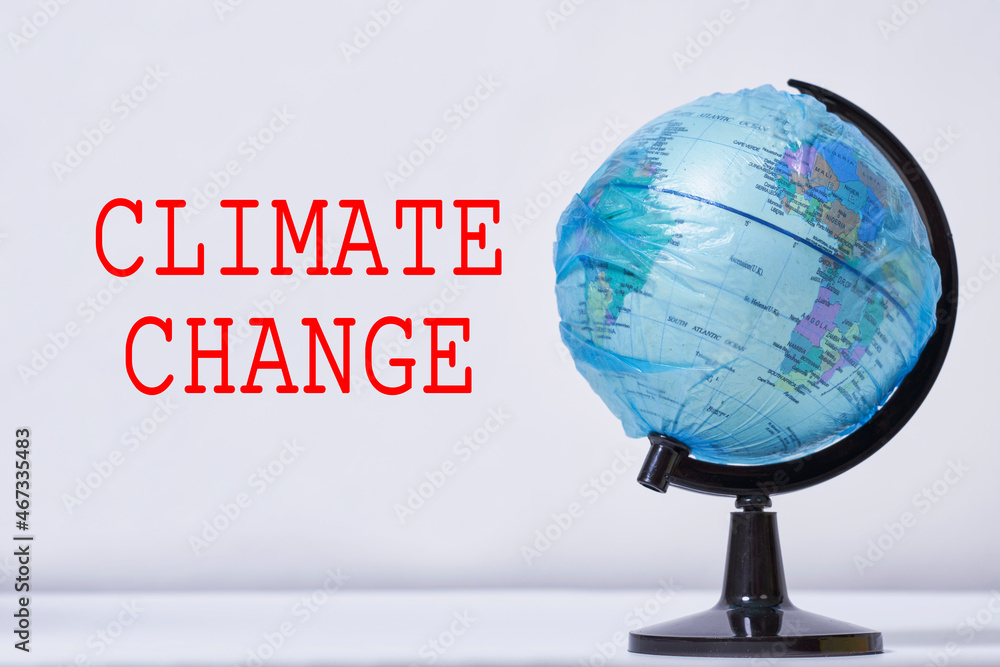 Climate change The Earth globe in plastic bag. A world globe wrapped