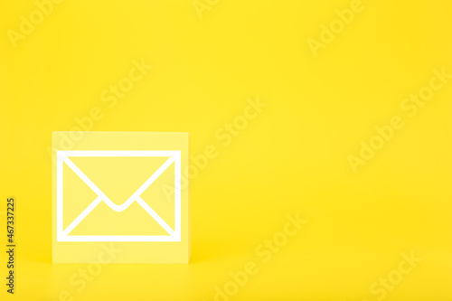 Obraz na płótnie Email marketing or newsletter concept. Envelope drawn on toy square against bright yellow background with copy space w salonie