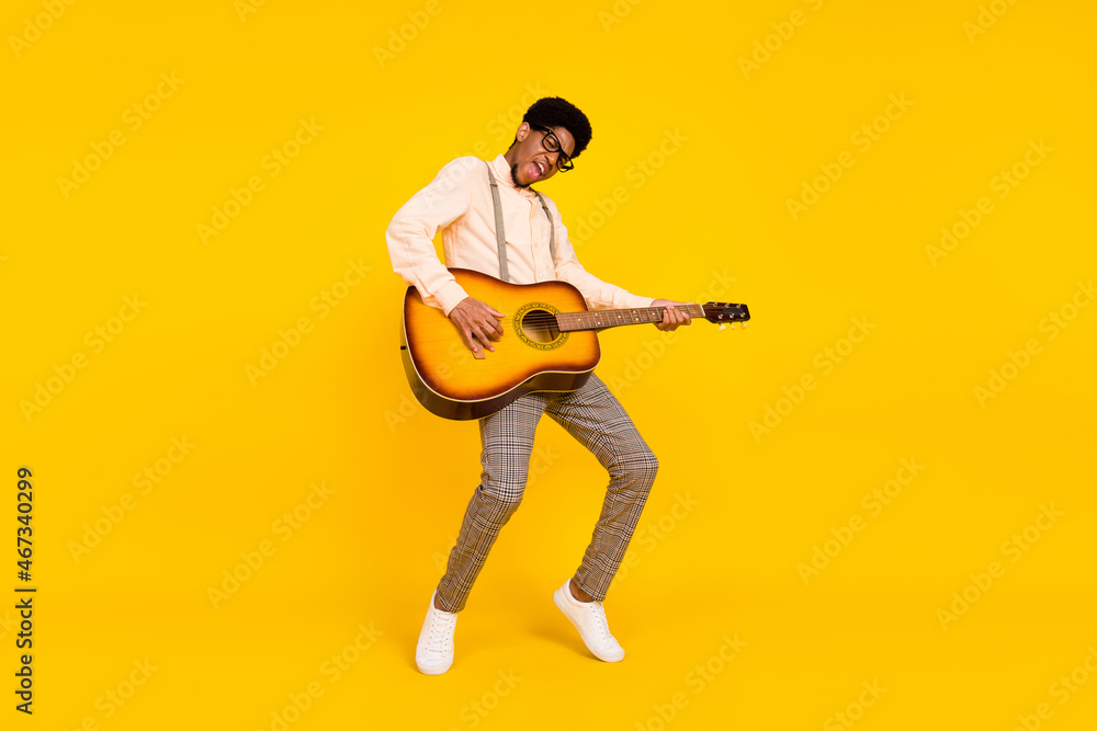 Photo of dancer guy play guitar stand tiptoe wear specs suspenders shirt isolated yellow color background - obrazy, fototapety, plakaty 