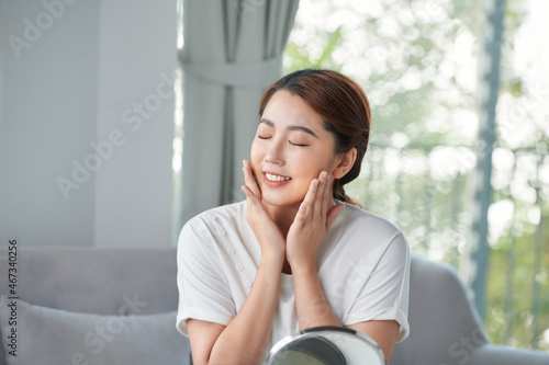 Happy young woman touching her face with hands Free Download Happy young woman touching her face with hands - GFXLoad