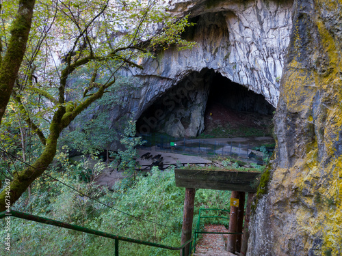 Entrance to Stopica cave which is located on the slopes of the mountain Zlatibor in Serbia photo