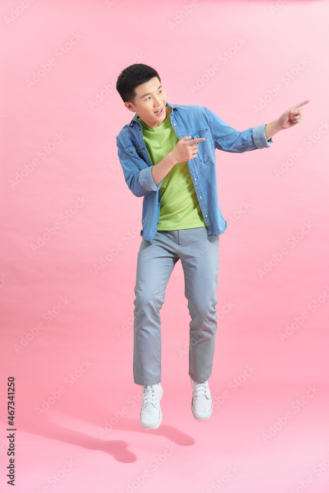 smiling young man jumping in air smiling young man jumping in air