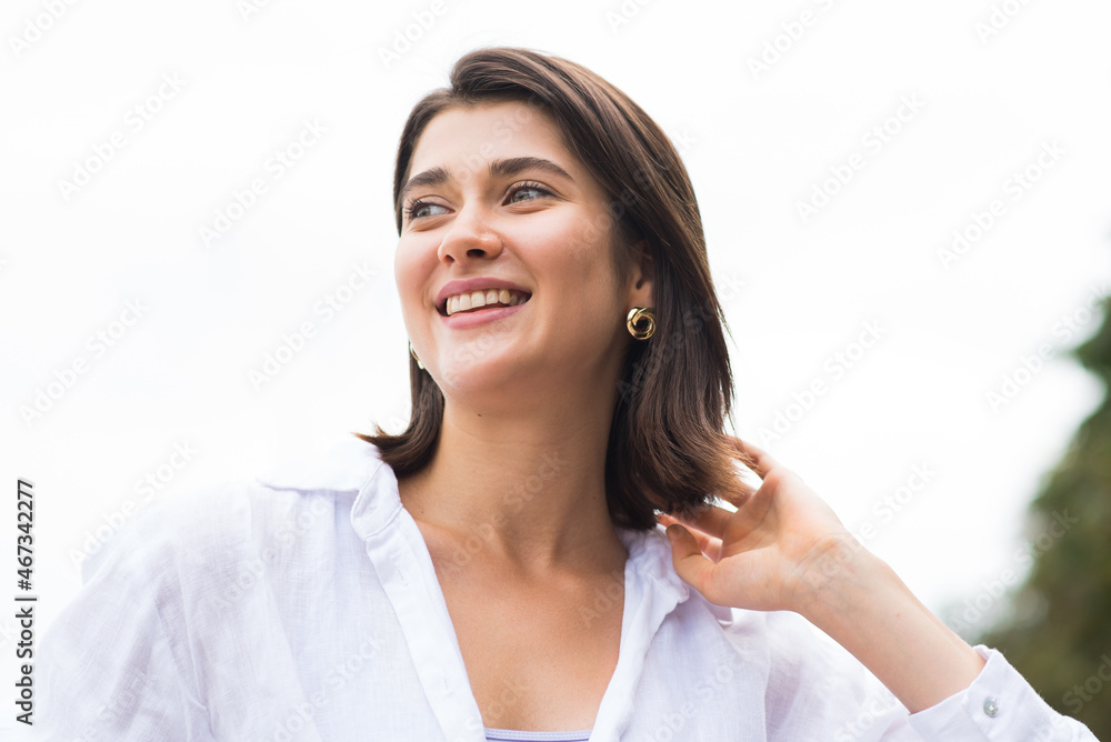 Attractive, happy and stylish brunette Caucasian girl posing on the street. Lifestyle and fashion concept. Attractive, happy and stylish brunette Caucasian girl posing on the street. Lifestyle and fashion concept.