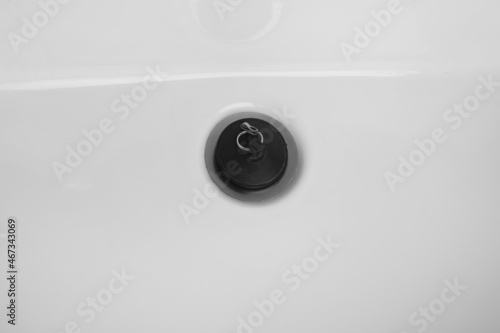 Detail of rubber bath plug. Drainage rubber stopper on white sink
