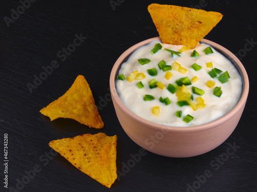 Sour cream with corn chips and hot chili