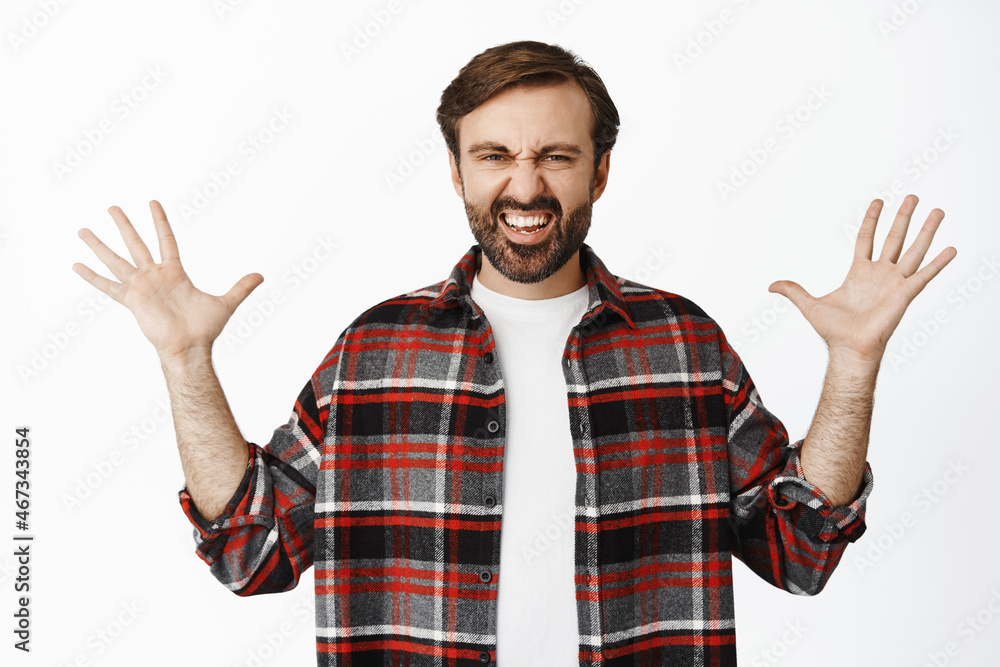 Enthusiastic bearded man spread hands sideways, showing something big, large sale promo deal, standing over white background Enthusiastic bearded man spread hands sideways, showing something big, large sale promo deal, standing over white background